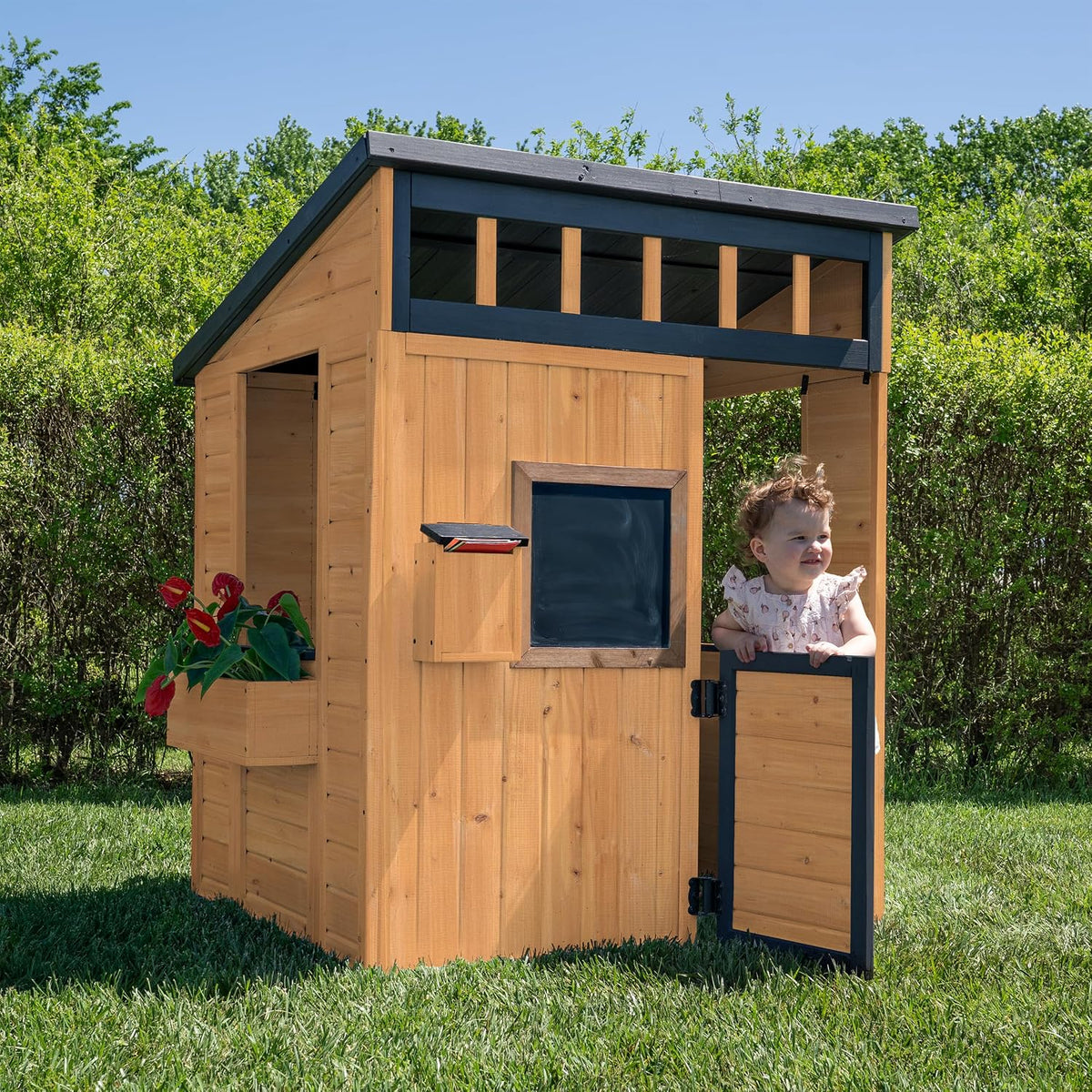 Caraway Cottage cedar playhouse in a backyard