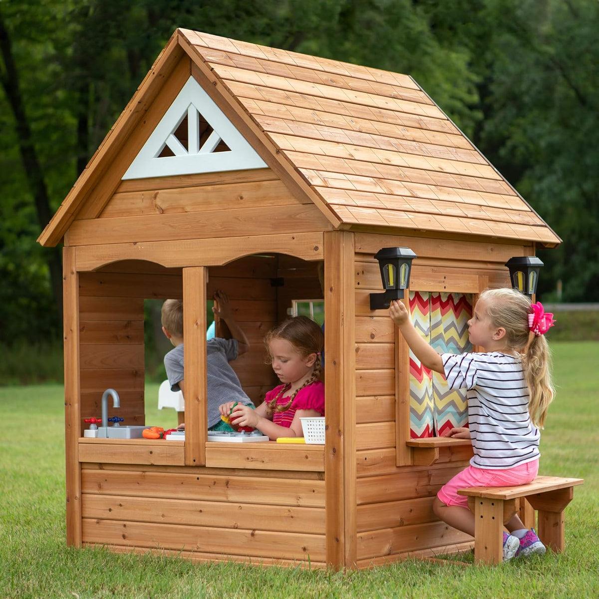 Backyard Discovery Aspen Cedar Wooden Kids Playhouse Cottage with Play Kitchen, Snack Bar, Picnic Bench, Dinner Bell, Mailbox, Dutch Door, Flowerpot Holders, Toy Lights, Country Style for Outdoor Play