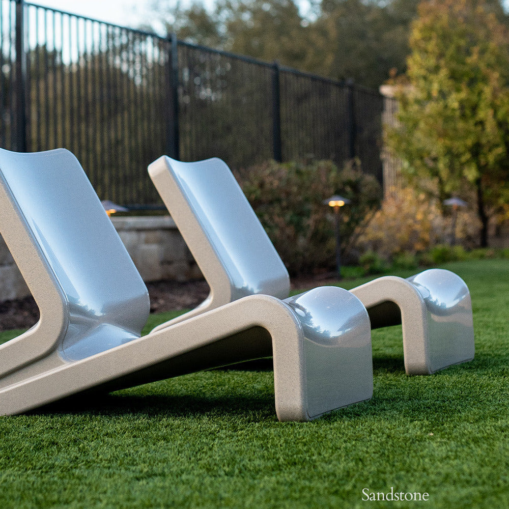 Modern outdoor chairs on grass with a blurred background
